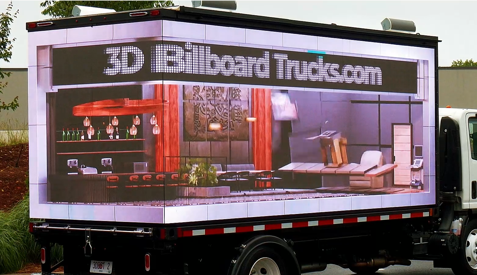 Seamless LED billboard truck with abutting screens displaying a 3D anamorphic animated video of a property transformation.