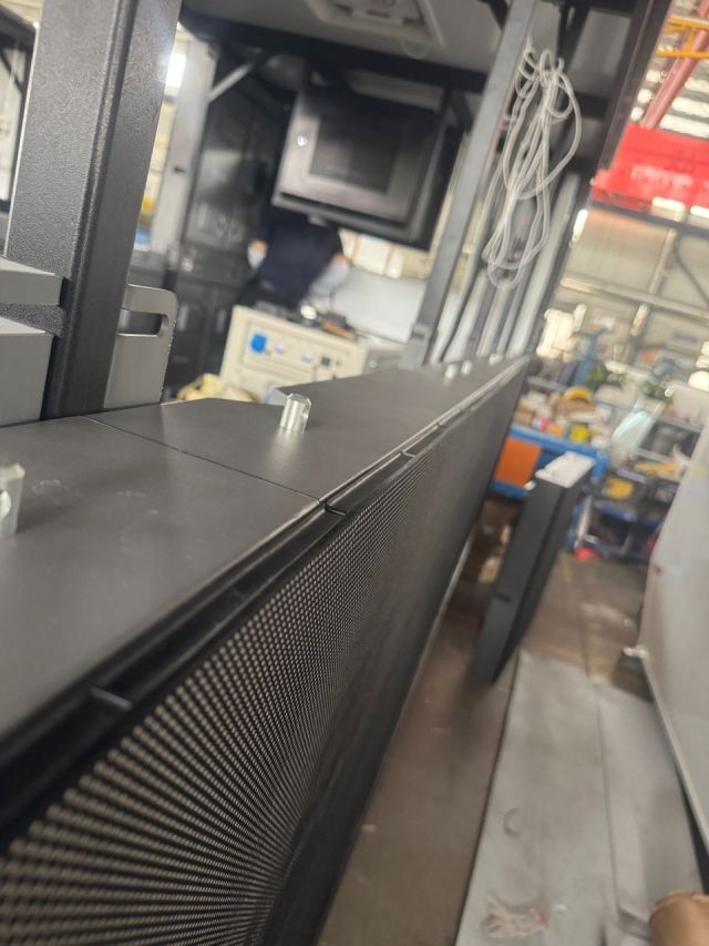 Quality control check confirming correct LED panel alignment on the LED billboard truck structure
